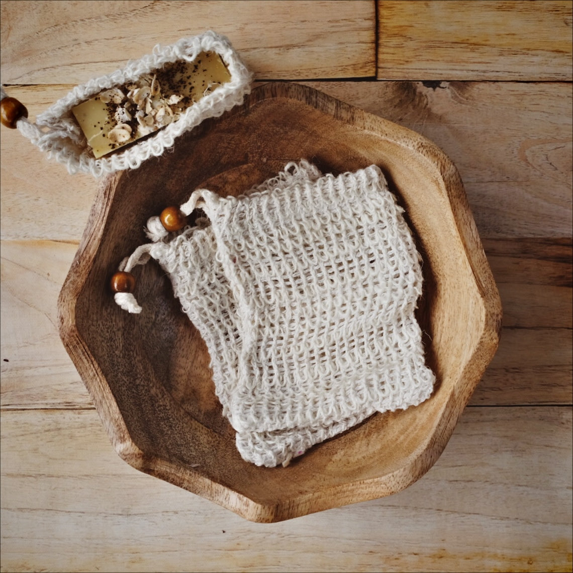 all natural sisal fiber soap saver bag with a brown bead.