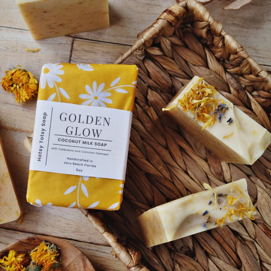 Golden Glow coconut milk soap is naturally scented with Lemongrass and lavender and naturally colored with calendula petals, colloidal oatmeal and kaolin clay. Each soap is decorated with dried herbs and botanicals and is wrapped in bright yellow paper with white flowers.