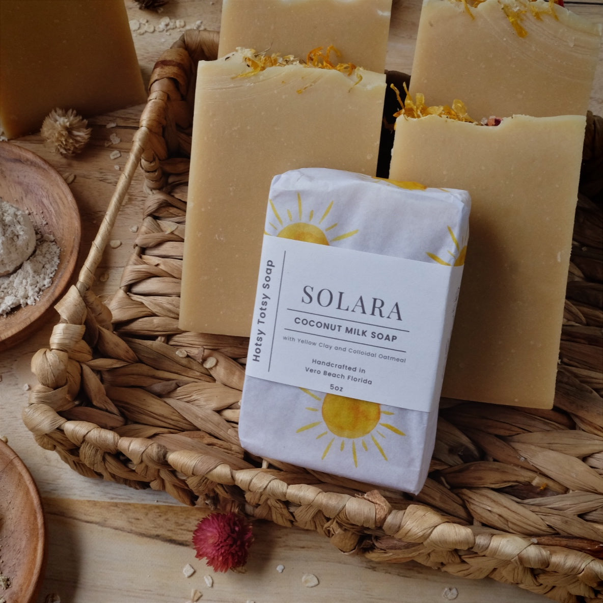 Golden coconut milk soap bars scented with lavender, litsea cubeba and geranium essential oils. Naturally colored with yellow clay, colloidal oatmeal and kaolin clay. Each soap comes wrapped in white paper with yellow suns and a cigar band label. 